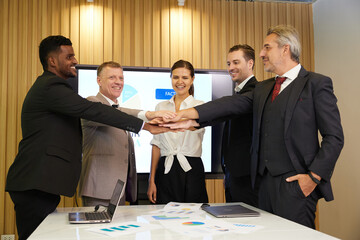 businesspeople putting their hands together from success work or project in the office