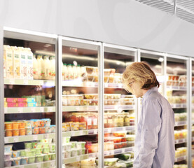 man choosing a dairy products at supermarket.