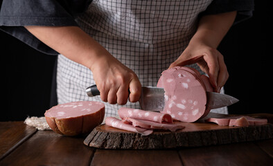 Mortadella. Traditional pork sausage with pistachios or black pepper. Italian delicacy from...