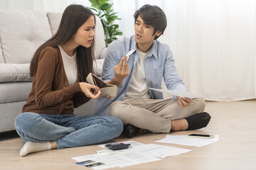 Fototapeta na wymiar Stressed financial owe asian young couple love sitting suffer, stressed and confused by calculate expense from invoice or bill, no money to pay, mortgage or loan. Debt, bankrupt or bankruptcy people.