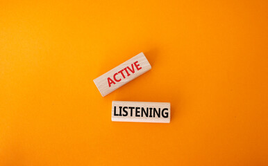 Active listening symbol. Wooden blocks with words Active listening. Beautiful orange background. Business and Active listening concept. Copy space.
