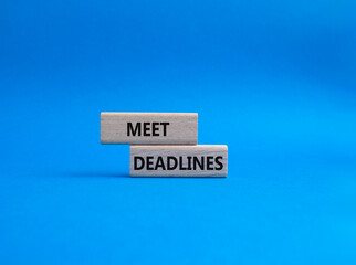 Meet Deadlines symbol. Concept word Meet Deadlines on wooden blocks. Beautiful blue background. Business and Meet Deadlines concept. Copy space