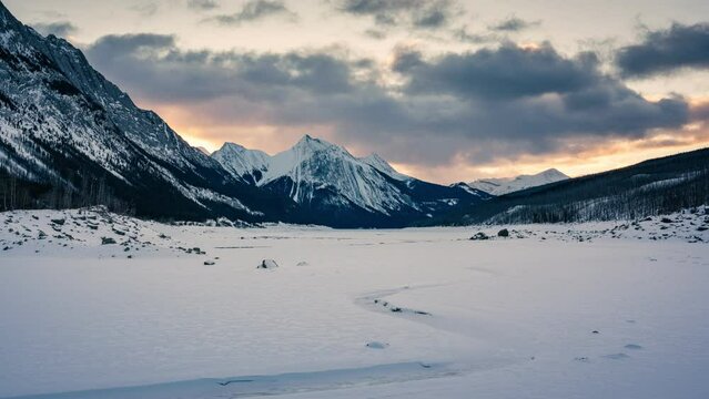 Scenery of Medicine Lake with colorful sky over rocky mountains in the morning on winter at Jasper national park