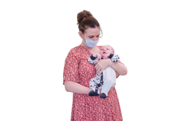 Woman mother in medical face mask holds baby boy, isolated on a white background. Mom with child son in her arms. Kid aged two months