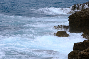 waves breaking on a Tuscan cliff