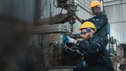 Industrial engineers inspect and perform maintenance on the machines at factory machines. Worker...