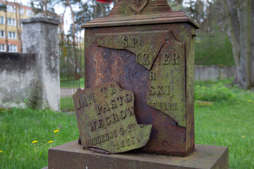 A cast-iron (broken) plaque on the grave of an Evangelical pastor from Węgrów