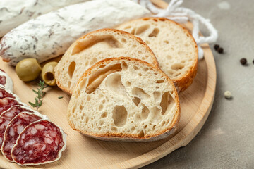 Fresh Homemade Italian Bread Ciabatta slised with fuet. Food recipe background. Close up