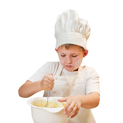 A child boy in white chef's clothes cooks food in a home kitchen, isolated on a white background