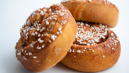 Three isolated cinnamon buns on white background. 