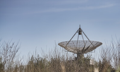 The metal structure of the astronomical radio telescope observatory on the territory of the Institute of the Ionosphere in the Kharkov region, on a spring sunny day