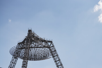 The metal structure of the astronomical radio telescope observatory on the territory of the Institute of the Ionosphere in the Kharkov region, on a spring sunny day