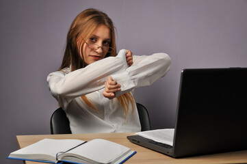 Portrait of an angry business woman sitting near the table and looking at the camera. Grumpiness and work concept