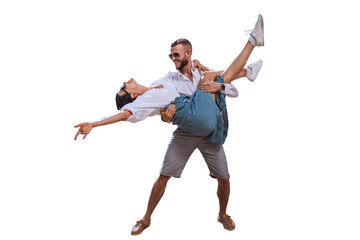 Happy caucasian couple in casual clothes sunglasses dancing against transparent background. Bearded young man lifting up girlfriend smiles. Travel, summertime leisure. Freedom concept, happiness.