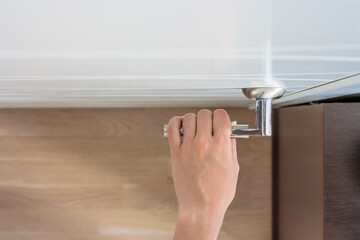 female hand open the door. Top view of woman arm holds door handle