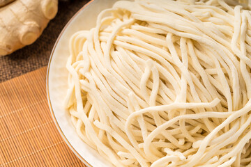 Fresh noodles against a simple background