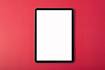 Tablet on a red background