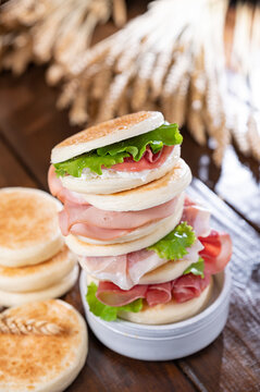 tigelle or crescentine homemade, con prosciutto, salame, stracciatella liquida. Italian food typical of the area of Modena, Emilia-Romagna. Thin round breads stuffed with prosciutto. 