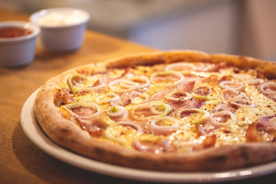 Oven pizza.  Pizza with toppings. Pizza with corn. Photo of the pizza. Pizza on a wooden table. 