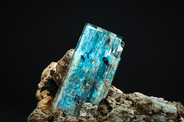 blue aquamarine with schorl (black tourmaline) inclusion. macro detail texture background. close-up...