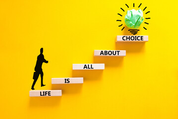 Choice and life symbol. Concept words Life is all about choice on wooden blocks. Beautiful yellow...