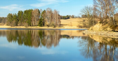 autumn view of pond and autumnal forest