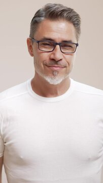 Portrait of happy casual older man smiling, Mid adult, mature age guy with gray hair in glasses, Isolated on white background, copy space.