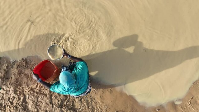 People Carrying Water From Swamp In Africa.