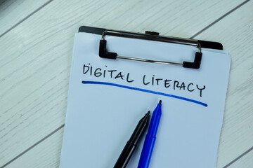 Concept of Digital Literacy write on paperwork isolated on Wooden Table.