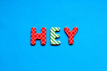 word hey on blue paper background