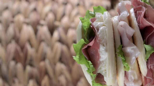 tigelle or crescentine homemade, con prosciutto, salame, stracciatella liquida. Italian food typical of the area of Modena, Emilia-Romagna. Thin round breads stuffed with prosciutto. 4k footage