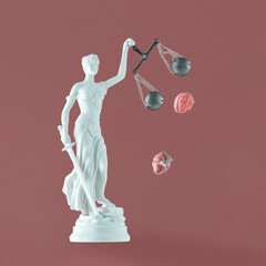 Pastel white statue of Lady Justice with human heart and brain fall out of scales on isolated...