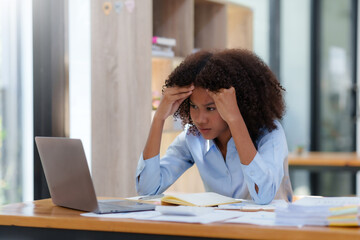 Businesswoman stressed with overwork in the office.