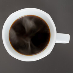 a cup of black coffee on gray background