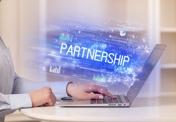 Closeup of businessman hands working on laptop