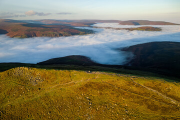 Aerial view of a mountain peak above a sea of fog in a temperature inversion (Sugar Loaf, Brecon Beacons)
