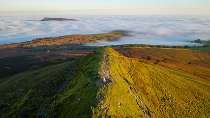 Aerial view of a mountain peak above a sea of fog in a temperature inversion (Sugar Loaf, Brecon...