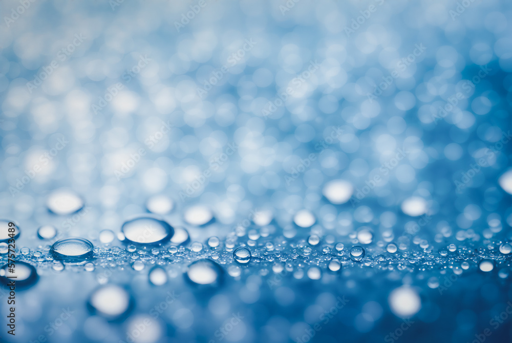 Poster droplet is perched delicately on a smooth surface with a background of sparkling bokeh lights.