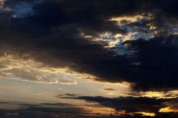 Dark clouds and sunrise sky with sun and rays