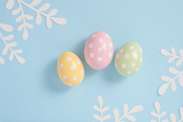 Fototapeta na wymiar Happy Easter Colorful Easter eggs flat lay on blue background. Stylish tender spring template with space for text. Greeting card or banner