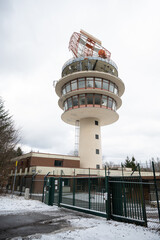 Neunkirchen radar tower during winter with gate and fence in front, low angle view, cloudy day...