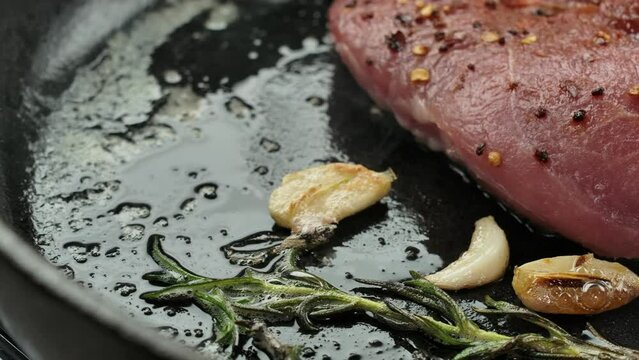 Panorama over hot pan with steak rosemary and garlic