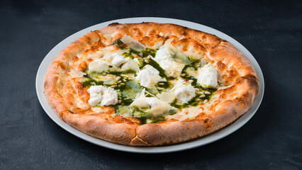 Italian pizza with spinach, cream cheese, parmesan and pine nuts.