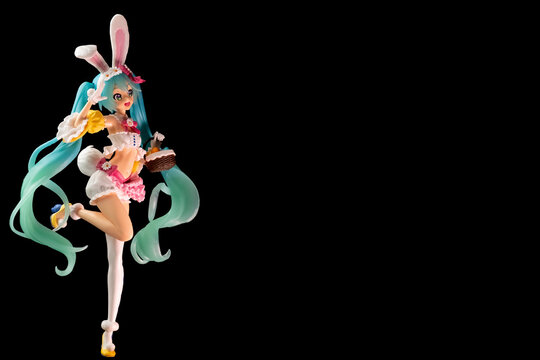 Russia, St. Petersburg, February 2023: Bunny, Easter bunny Hatsune Miku figurine with a basket on a black background, a place for a copy space
