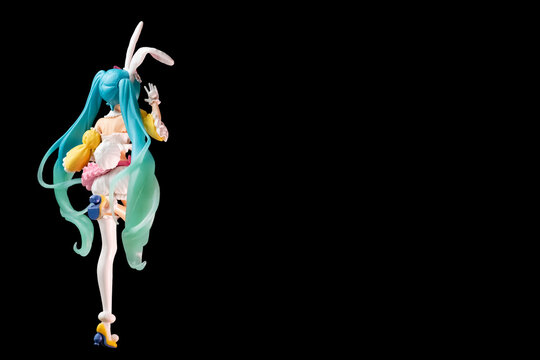 Russia, St. Petersburg, February 2023: Bunny, Easter bunny Hatsune Miku figurine with a basket on a black background, a place for a copy space