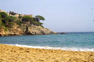 view from the beach in Cala de la Fosca to the Castle ruins of Castell de Sant Esteve, Palamos,...