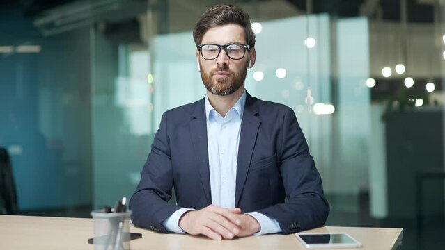 Webcam view of confident mature business man investor in fofmal suit looking at camera greeting talking by online meeting conference video call at modern workplace indoors Working conversation remote