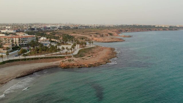 Drone point of view Playa Flamenca beach and seafront promenade. Costa Blanca. Province of Alicante. Spain. Travel and tourism concept