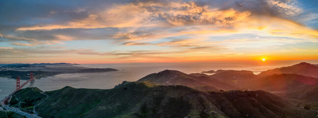 Sunset over Pacific Ocean with Golden Gate Bridge and Marin Headlands