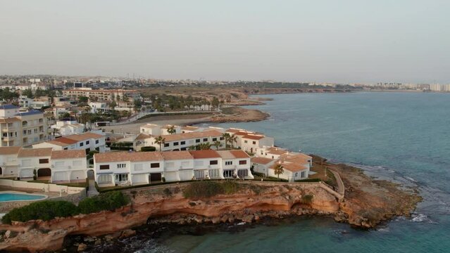 Drone point of view of coastal houses in the Playa Flamenca. Costa Blanca. Province of Alicante. Spain. Travel and tourism concept